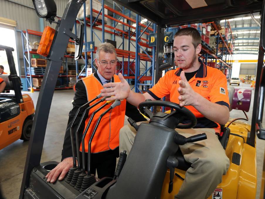 A young Australian shows off his new forklift operating skills. 